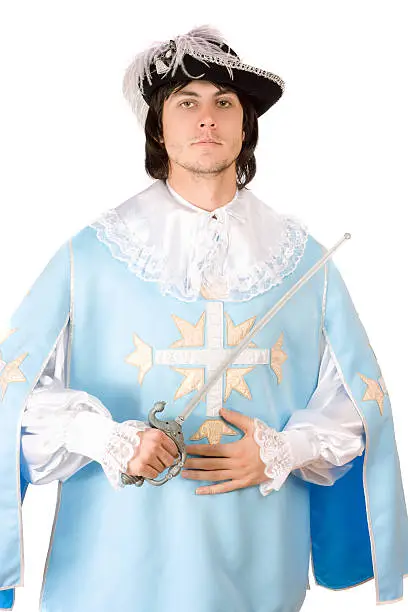 Young man with a sword dressed as musketeer, Isolated