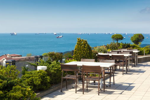 Empty cafe tables high over city and Marmara sea, Istanbul, Turkey