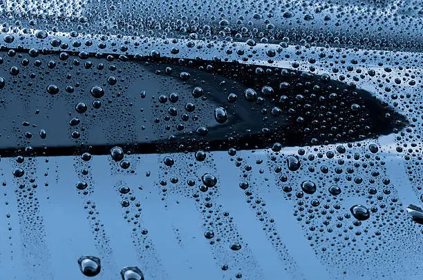 Waterdrops on a polished black lacquer surface.