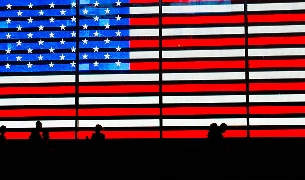 istock Silhouettes and Neon American Flag at night 186354401