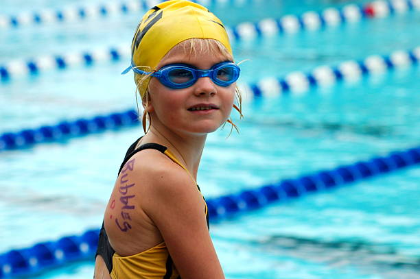 A young swimmer gets ready for her race at a swim meet.