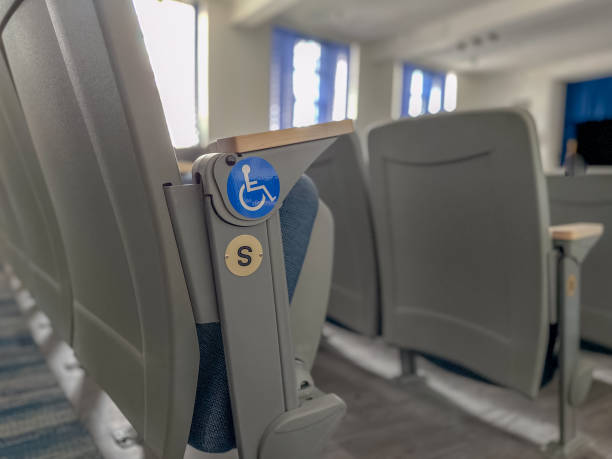 istock Close up image of empty ADA, accessible, gray and blue theater, auditorium seats, chairs. 1863551377