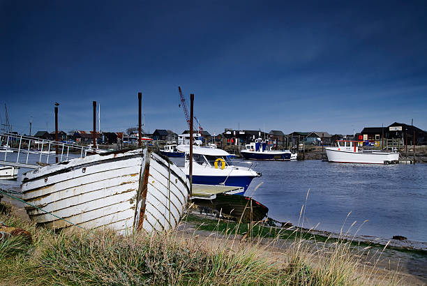 Distressed fishing boat Taken on a summer’s afternoon the image shows an abandoned fishing boat on the river bank Walbeswick, in Southwold Harbour. southwold stock pictures, royalty-free photos & images