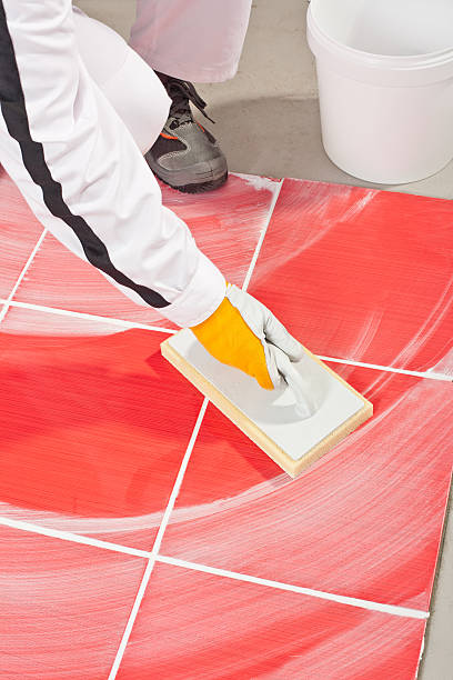 istock worker clean with sponge trowel tile joints grout 186357224