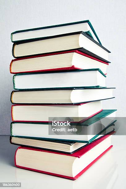 Stack Of Books On White Reflective Surface Stock Photo - Download Image Now - Abundance, Aging Process, Antique