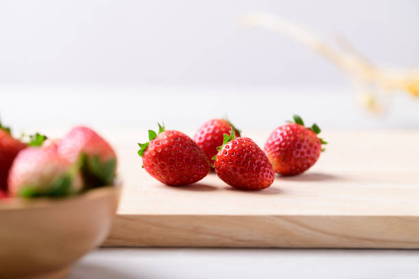 istock Fresh strawberry fruit on cutting wooden board 1863613536