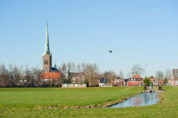 istock Typical Dutch village scenery against dike 186362054