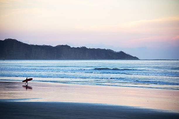 istock Sunset surfer at the end of a perfect day 186365085