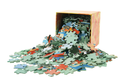 Jigsaw Puzzle Pieces and Box on White Background