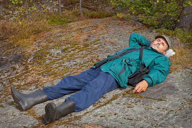 istock Elderly tourist resting on the rock 186365573