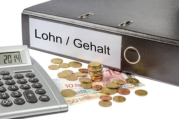Lohn Gehalt Binder Calculator and Currency A Binder labeled wit the word Lohn Gehalt (German wage, salary) calculator and european currency isolated on white background tabs ring binder office isolated stock pictures, royalty-free photos & images