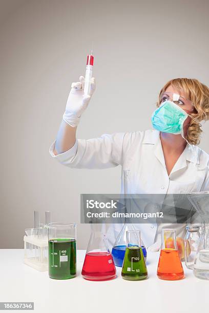 Female Laboratory Worker Experimenting Stock Photo - Download Image Now - 30-34 Years, 30-39 Years, Adult