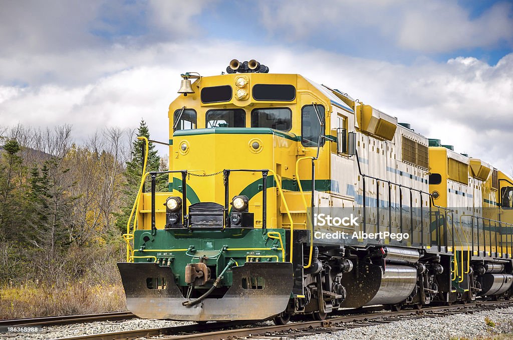 Powerful Diesel Locomotive and Cloudy Sky A powerful diesel locomotive in the White Mountain Area, New Hampshire, on cloudy autumn day Diesel Fuel Stock Photo