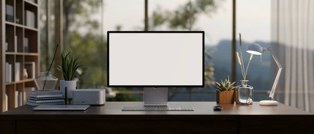 istock A modern private office room with a computer mockup on a desk, large glass window on the back. 1863708221