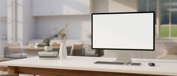 istock A modern luxury white home living room with a computer mockup and accessories on a white desk. 1863708855