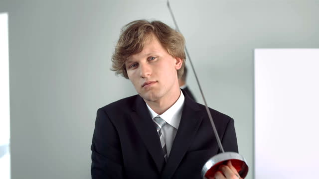 HD Super Slow-Mo: Portrait Of Businessman With Fencing Foil