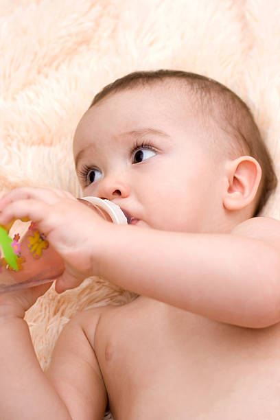 istock Little caucasian boy drinking from the bottle 186374885