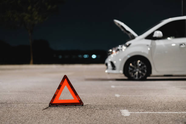 istock Warning road sign on road with broken car 1863763739