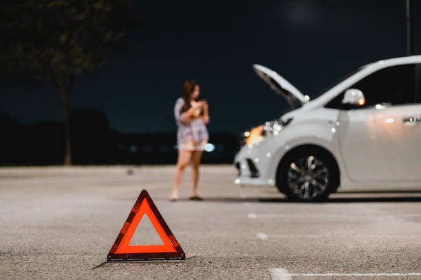 istock A lady's car brake down at open space parking lot and waiting for help 1863763747