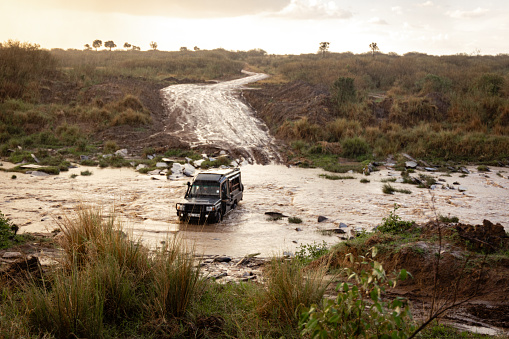 a Toyota Land Cruiser traversing the Talek River in Masai Mara National Reserve, Kenya