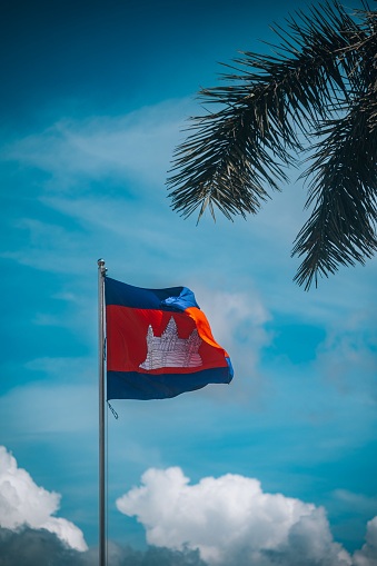 Cambodia flag waving on the flagpole against blue  sky.