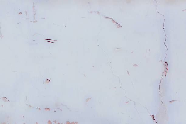 istock White plaster wall with deep scratches and chips. Various variations of abrasions. 1863768372
