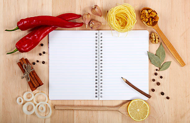 istock Notebook for recipes, vegetables and spices on wooden table. 186377289