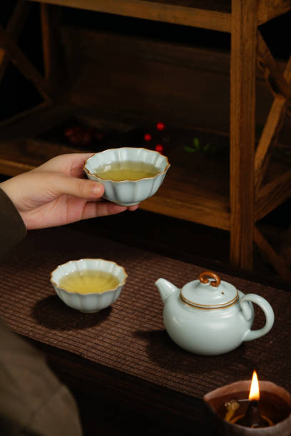 istock Image of woman's hands making tea, Asian style, tea set on the table 1863784934
