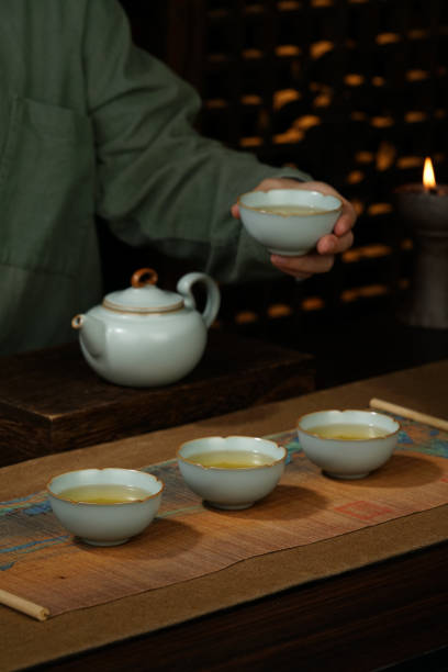 istock Image of woman's hands making tea, Asian style, tea set on the table 1863785452