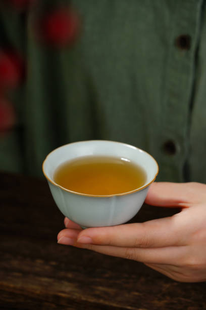 istock Image of woman's hands making tea, Asian style, tea set on the table 1863785962