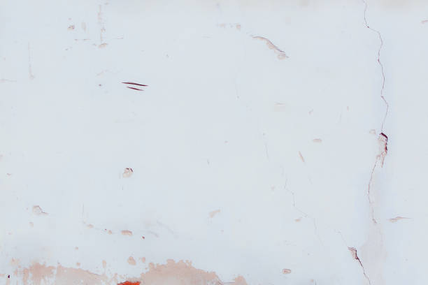 istock White plaster wall with deep scratches and chips. Various variations of abrasions. 1863793179