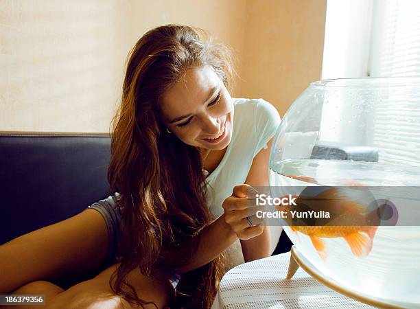 Pretty Woman Playing With Goldfish At Home Sunlight Morning Stock Photo - Download Image Now