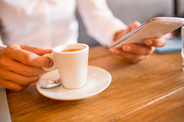istock Woman looking at her smart phone and drinking coffee 186379497