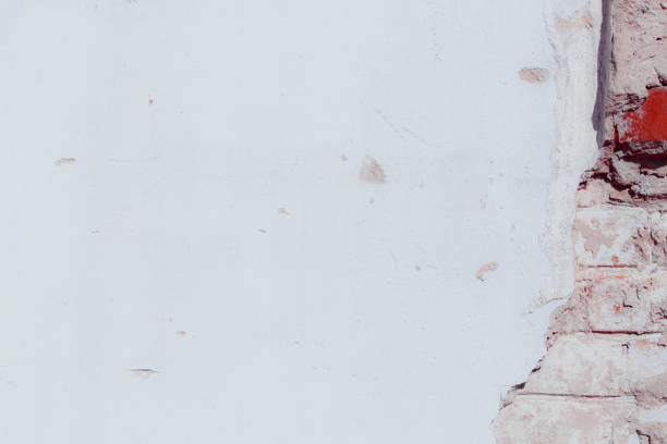 istock White plaster wall with deep scratches and chips. Various variations of abrasions. 1863796750