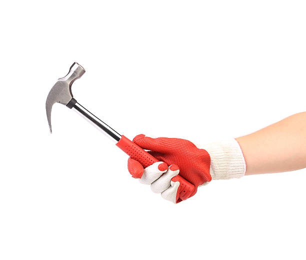 istock Hand in glove holding metal hammer. 186380719