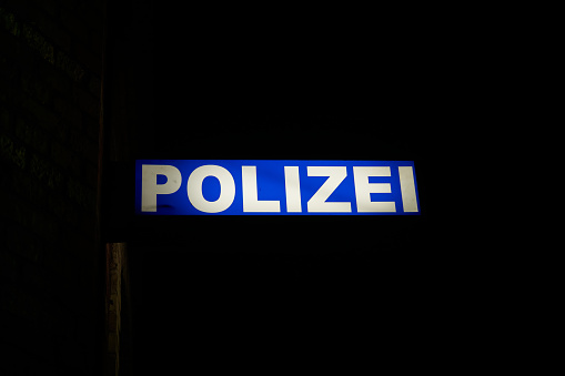 Neon light of a police station in the port of Stralsund in Germany at night