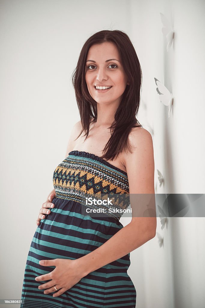 Pregnant woman Pregnant woman put her hands her belly on standing at the window Abdomen Stock Photo