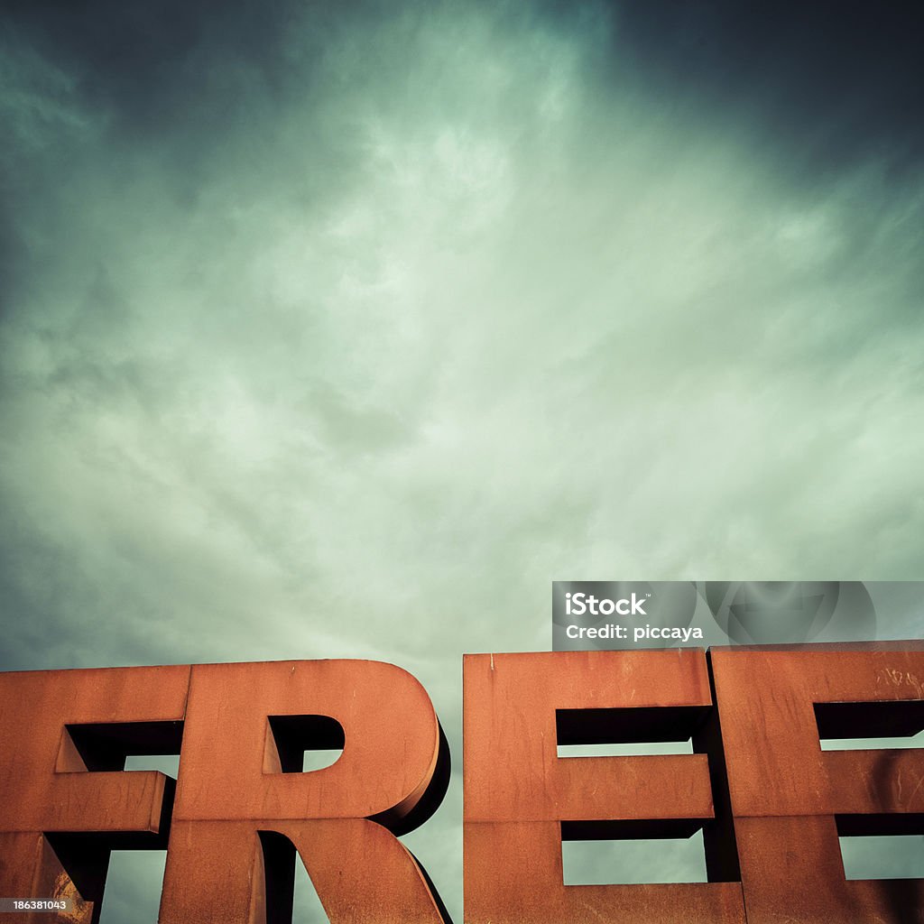 Capital letters FREE with cloudy sky Isolated single word FREE from volumetric letters with a dramatic sky in the background Free of Charge Stock Photo