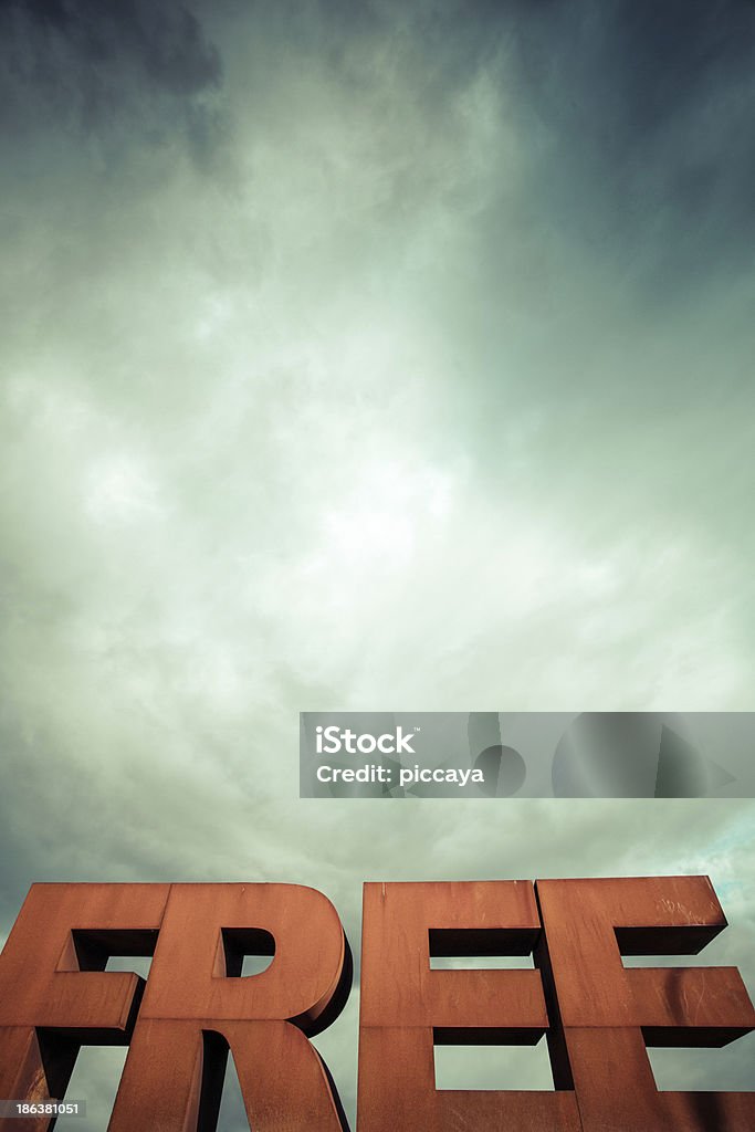 Capital letters FREE with cloudy sky Isolated single word FREE from volumetric letters with a dramatic sky in the background Advertisement Stock Photo