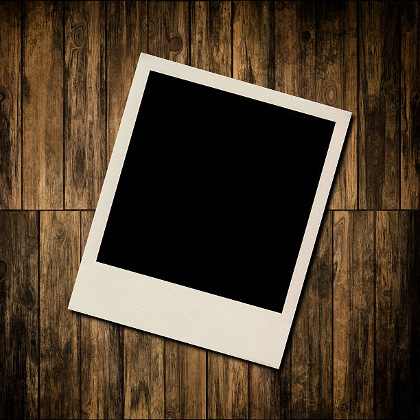 istock Blank instant photo frame on old wooden background 186381451