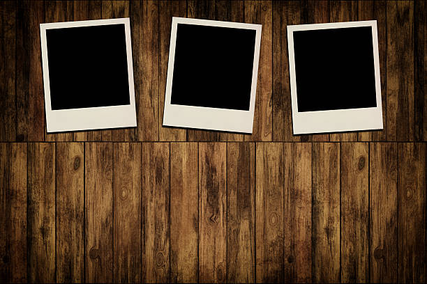 istock Blank instant photo frames on old wooden background 186381461