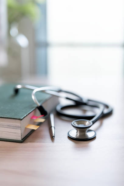 istock Health care concept, Stethoscope and book on white table 1863826583