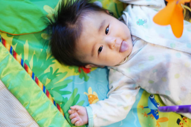 istock Baby sticking out tongue 1863827104