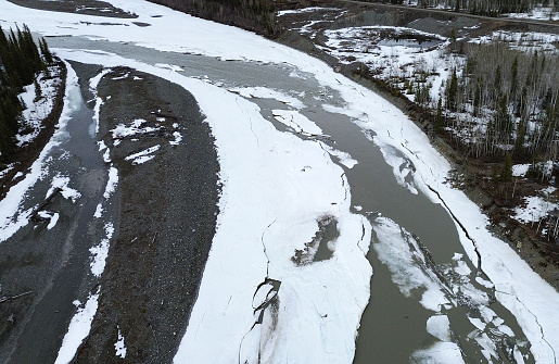 Spring break up allows winter ice to flow down the river.