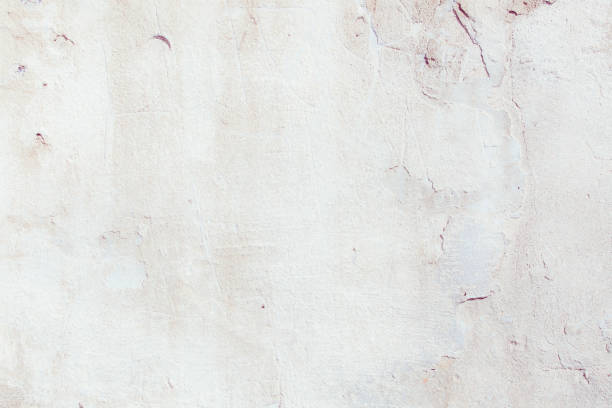 istock White plaster wall with deep scratches and chips. Various variations of abrasions. 1863891130