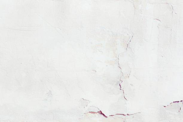 istock White plaster wall with deep scratches and chips. Various variations of abrasions. 1863891648