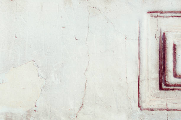 istock White plaster wall with deep scratches and chips. Various variations of abrasions. 1863892171
