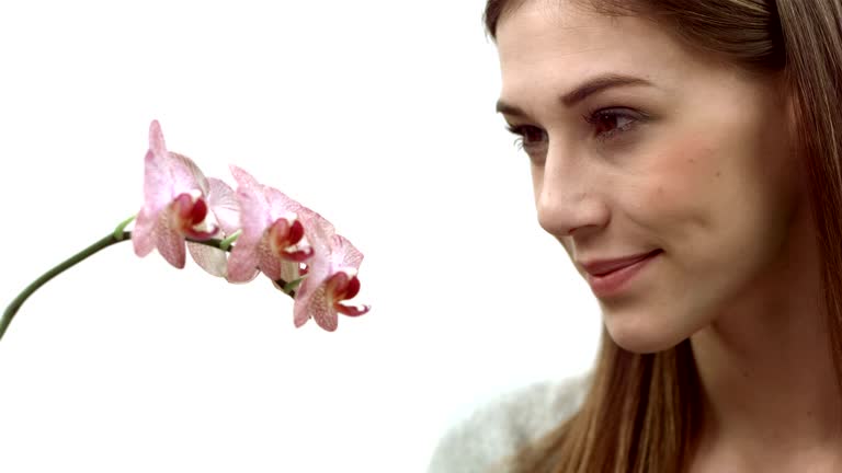 HD: Woman Smelling An Orchid