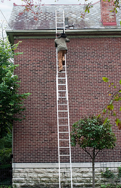 istock Man Carrying Slate up Ladder 186391579