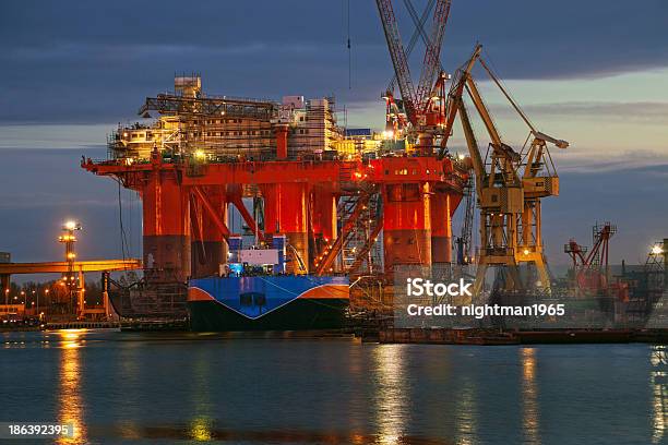 Massive Oil Rig Facilities Along Shore At Sunset Stock Photo - Download Image Now - Crude Oil, Natural Gas, Oil Production Platform